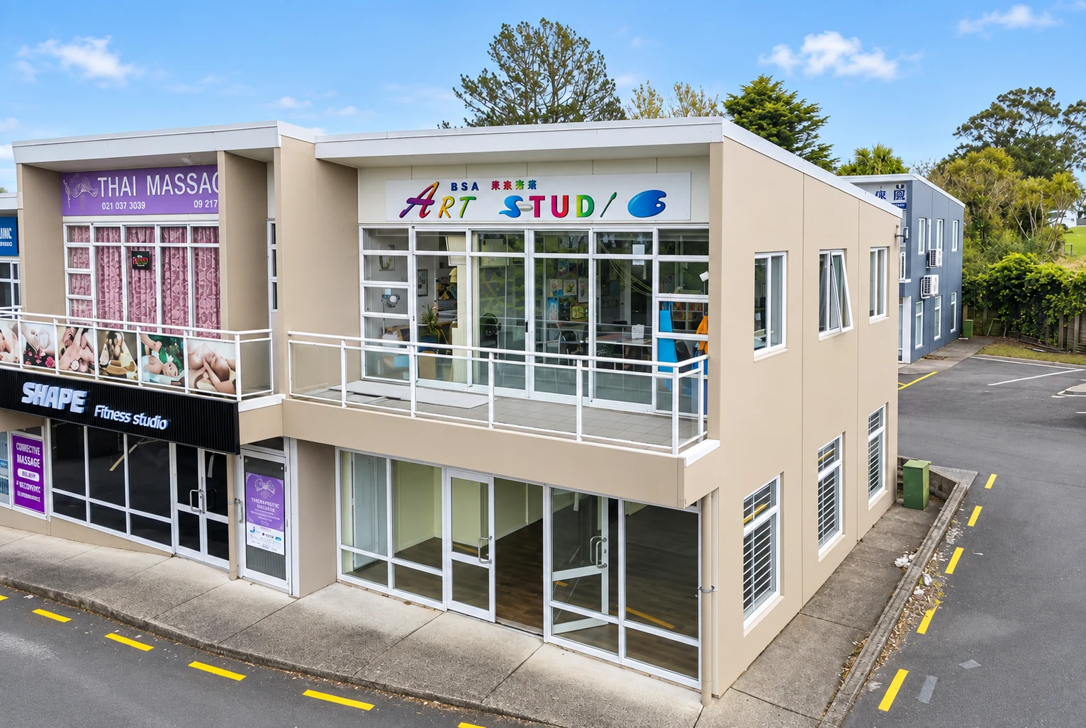 Wide daylight view of the building with the S&A ART STUDIO sign visible above the upstairs studio