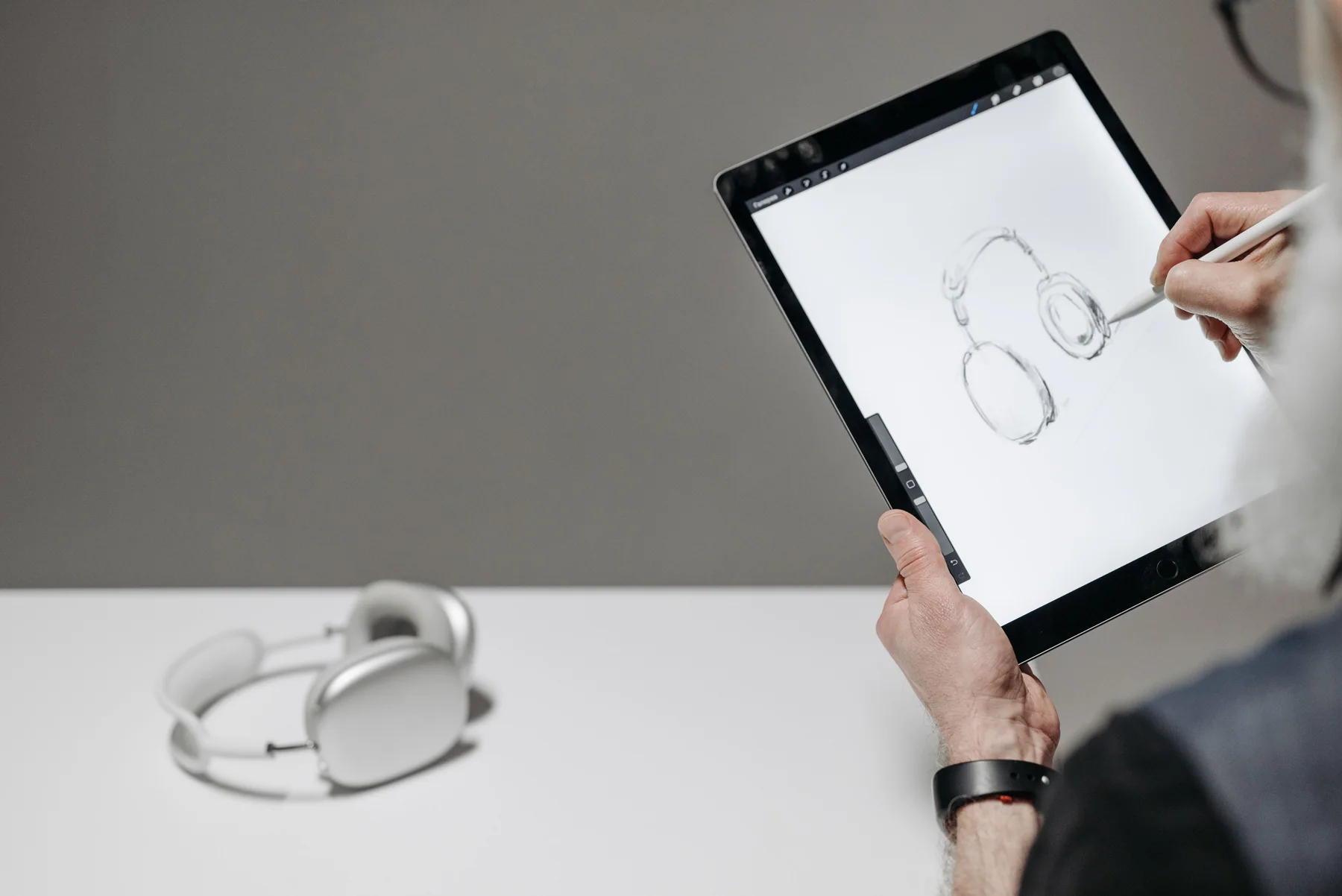 Artist drawing on a tablet with a stylus as part of a digital illustration workflow