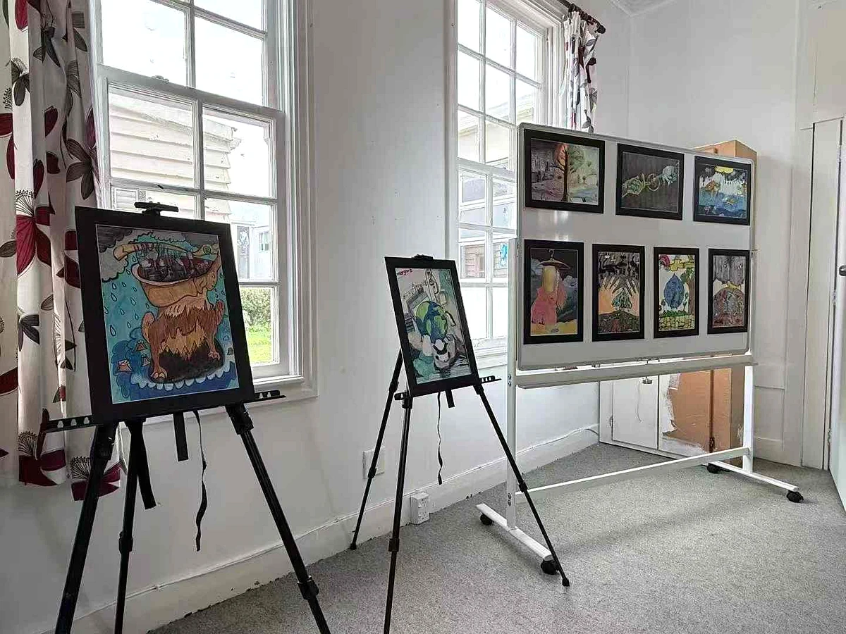 Artwork displayed on easels and walls in the bright S&A studio